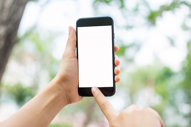 Woman's hand holding smart phone with blur background. 