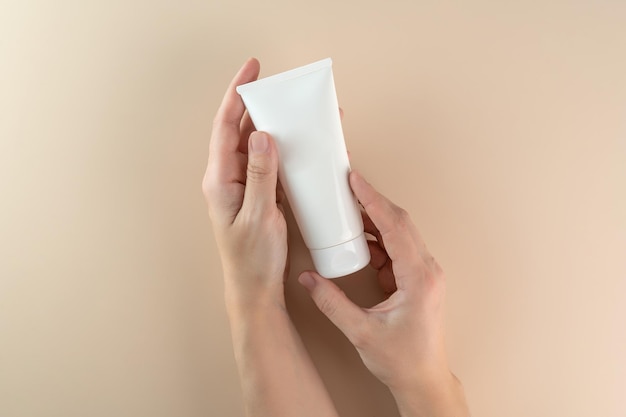 A woman's hand holding a white cube of cream serum gel for face care Cream mockup Marketing product presentation