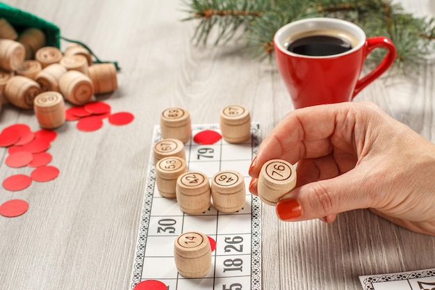 Woman's hand holding a wooden barrel for a game in lotto Boar