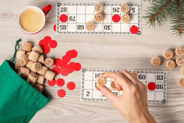 Woman's hand holding a wooden barrel for a game in lotto