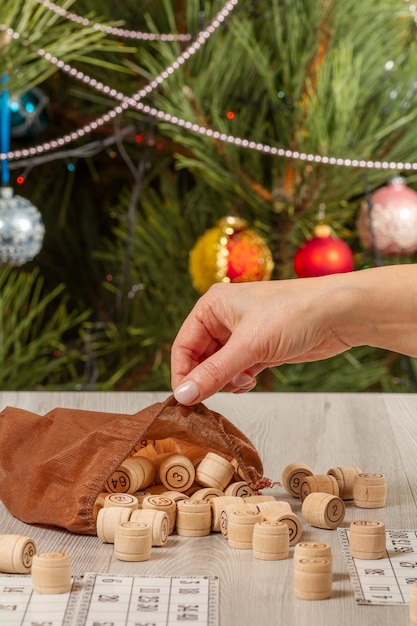 Woman's hand holding a wooden barrel for a game in lotto