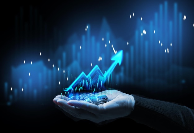 A woman's hand holds a stack of change against the background of a graph the concept of cost growth energy growth profit loss