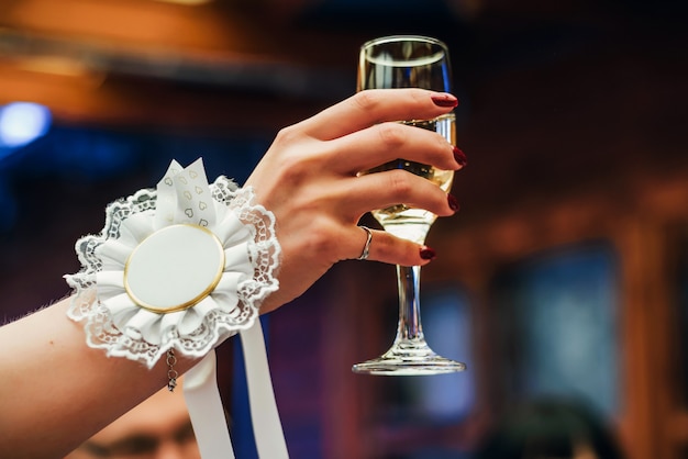 Woman's hand lifting a glass of champagne up