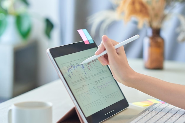 A woman's hand operating a tablet PC in the room