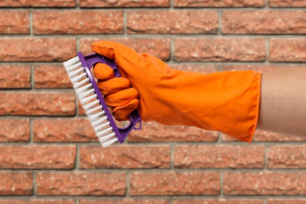 Woman's hand in protective glove with brush