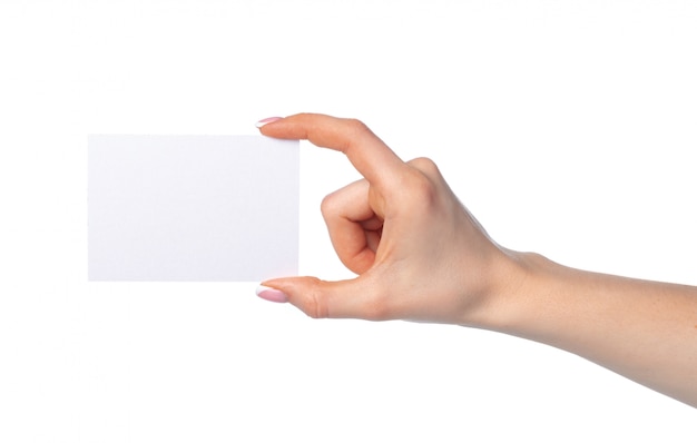 Woman's hand with blank white business card isolated on white