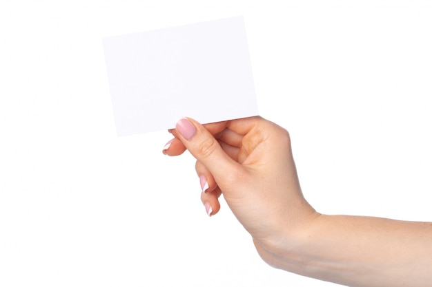 Woman's hand with blank white business card isolated on white