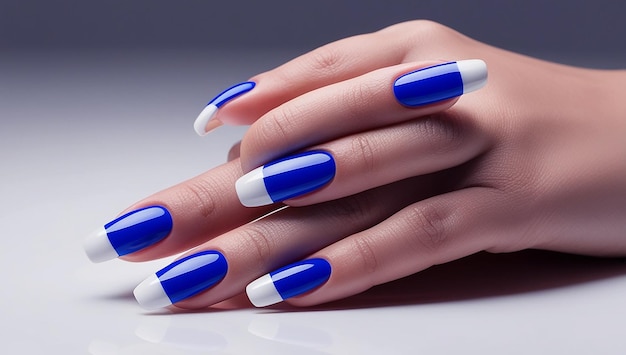 a woman  s hand with a blue and white nail polish