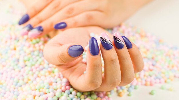 Woman's hand with polish nails Crop unrecognizable person showing manicure Concept of care and beauty Macro