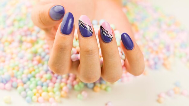 Woman's hand with polish nails Crop unrecognizable person showing manicure Concept of care and beauty Macro