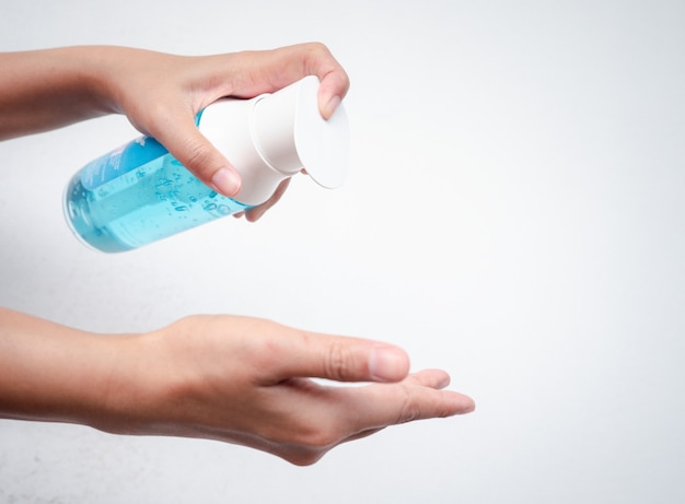 A woman's hands are washing their hands with alcohol gel to kill the Coronavirus