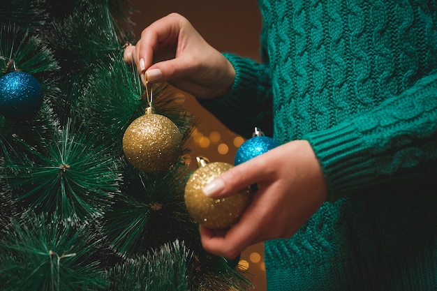 Woman's hands decorating the Christmas tree