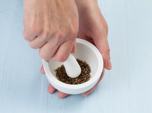 Woman's hands grinding coriander