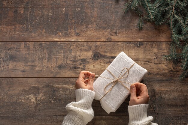 Woman's hands holding a Christmas gift