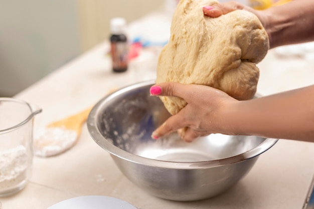 Woman's hands kneading ingredients to make pan de muerto