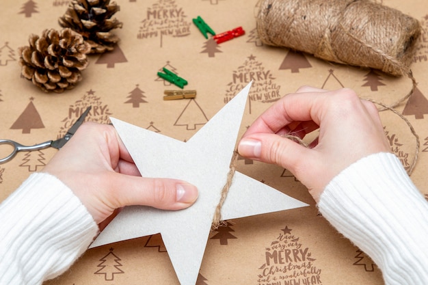 Woman's hands making a Christmas ornament