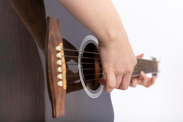 Woman's hands playing acoustic guitar, closeup