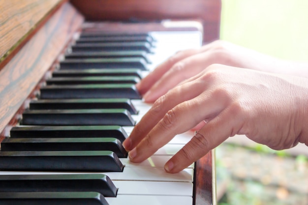 Woman's Hands Playing The Piano. Retro Style. Warm Color Toned.