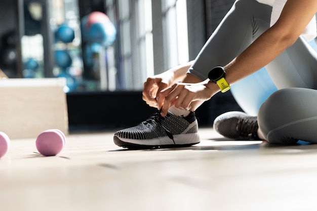 Woman's hands tying shoes Get ready to exercise at gym 