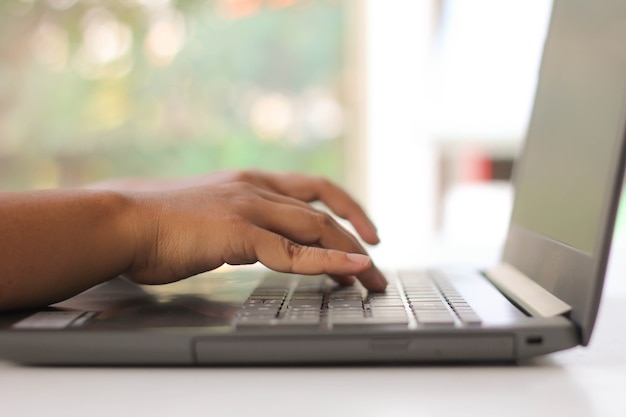 Woman's hands typing on laptop keyboard : Selective Focus