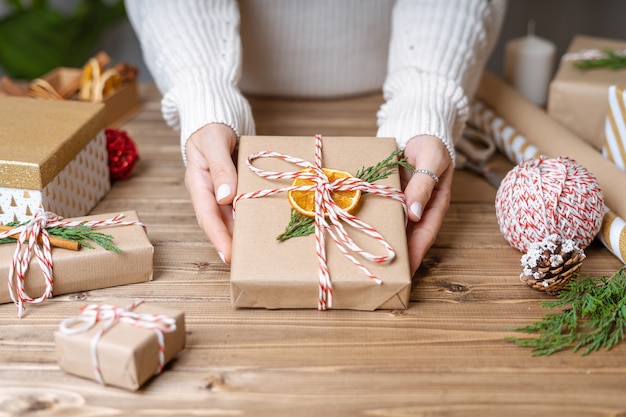 Woman s hands wrapping Christmas gift