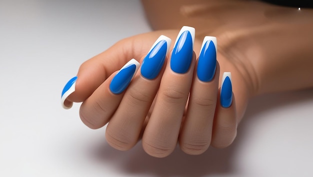 a woman  s manicure with blue and white nail polish