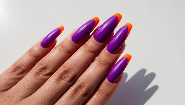 a woman  s nails with bright purple nails with orange and purple nail polish