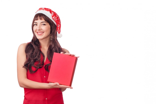 Woman in santa hat holding Christmas gift box