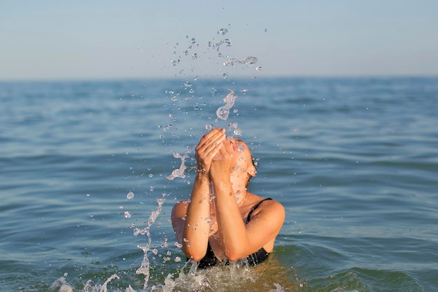 Woman in the sea with splashes of water