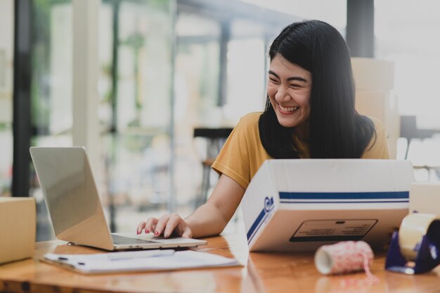 Woman selling products online video calling with smiling customers, Selling products online, Delivering parcels.