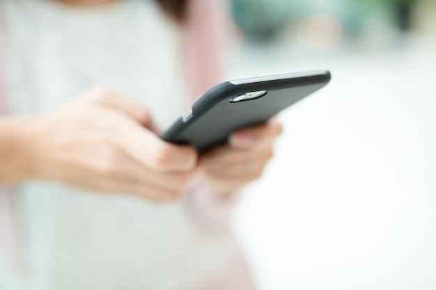 Woman sending sms on cellphone