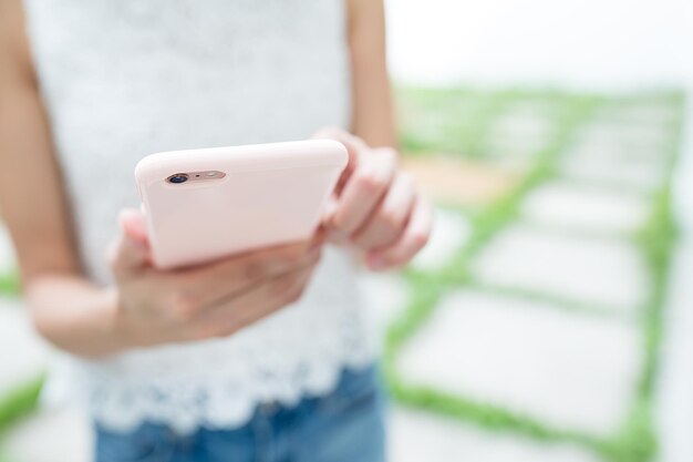 Woman sending sms on cellphone