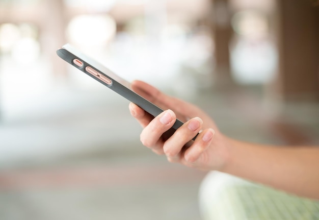 Woman sending sms on smart phone