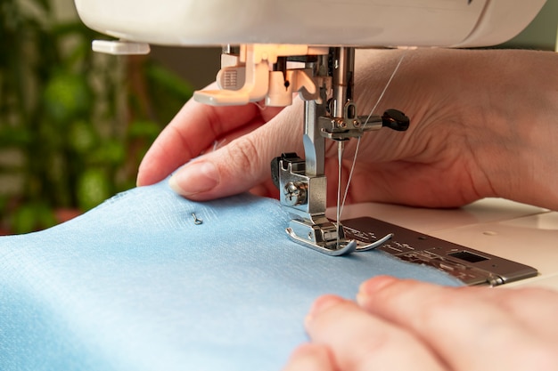 Woman sews on a sewing machine