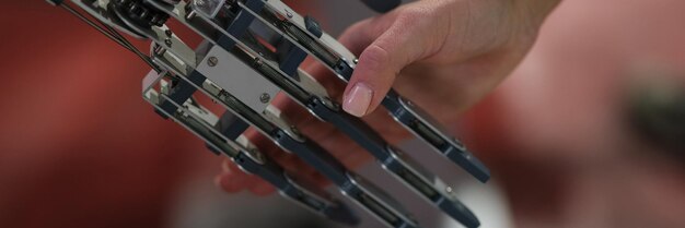 Woman shaking hand with metal prosthesis closeup