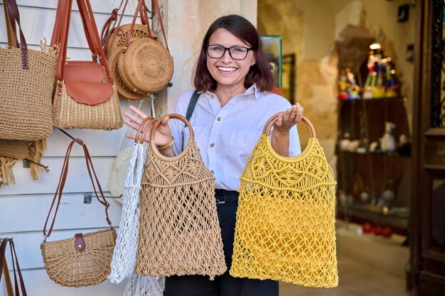 Woman shopper buying a trendy woven eco bag in the store