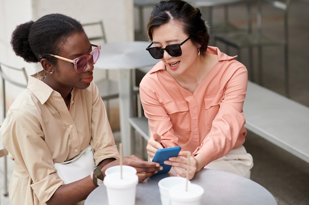 Woman Showing Online Shop to Friend