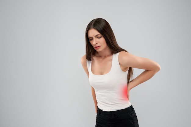 Woman showing pain in back