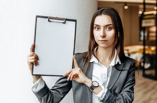 The woman shows information on the tablet