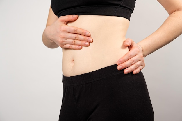 A woman shows the location of the pancreas and spleen