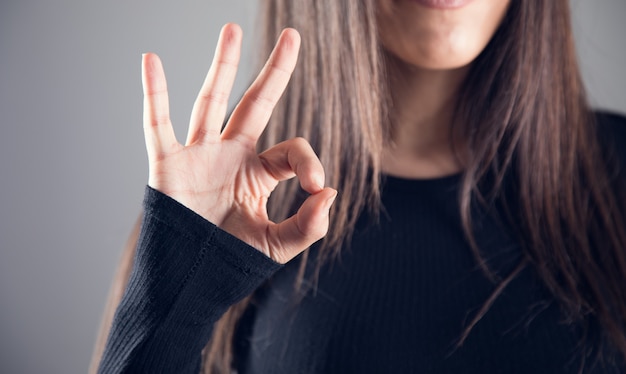 Woman shows ok gesturewoman showing ok gesture with fingers