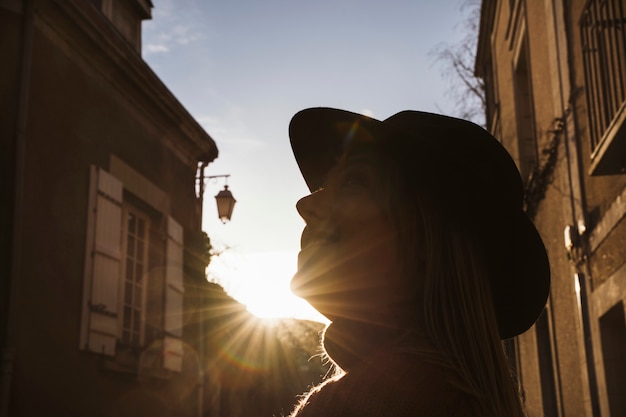 Woman sightseeing the streets of Angers, France at sunset