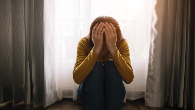 Woman sit Depression Standing by window and anxiety Copy space xAxA