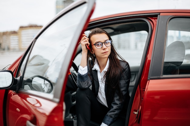 The woman sits in the car