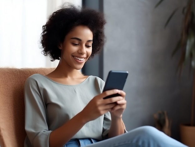 A woman sits on a couch and looks at her phone.