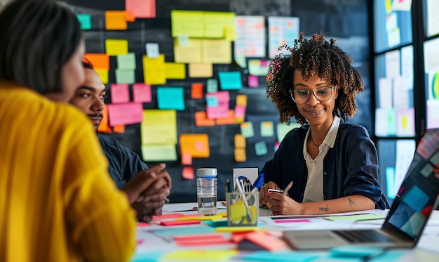 Photo a woman sits at a table with a note that says  post it  on it