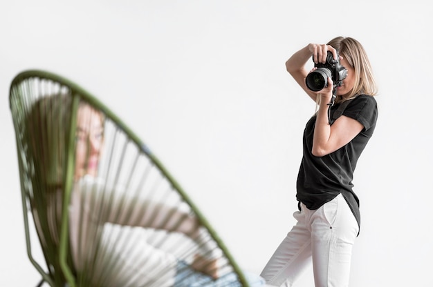 Woman sitting on a chair and being photographed