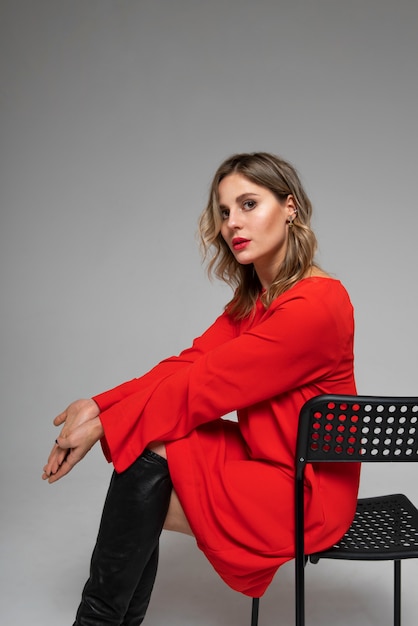 Woman sitting on chair side view