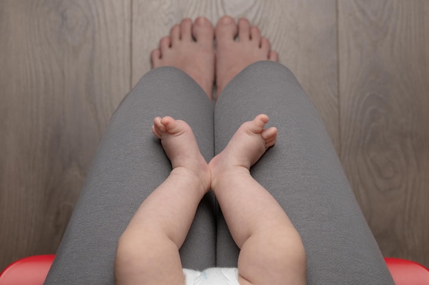 Woman sitting on chair with baby top view