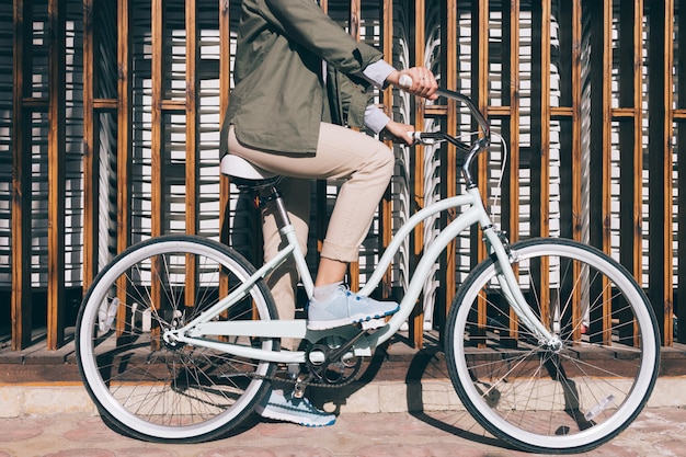 Woman sitting on the city bicycle outdoors